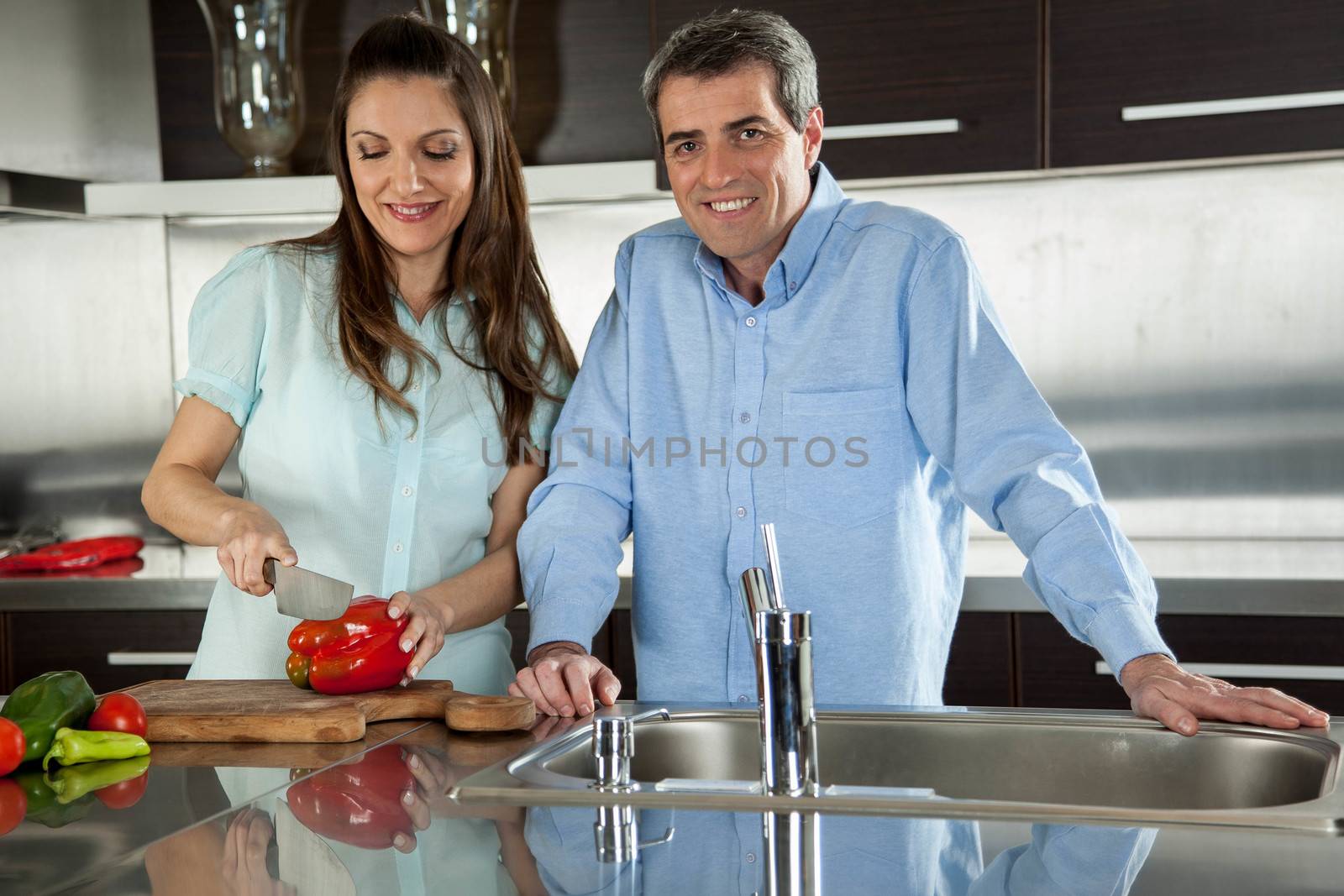 couple cooking with vegetables