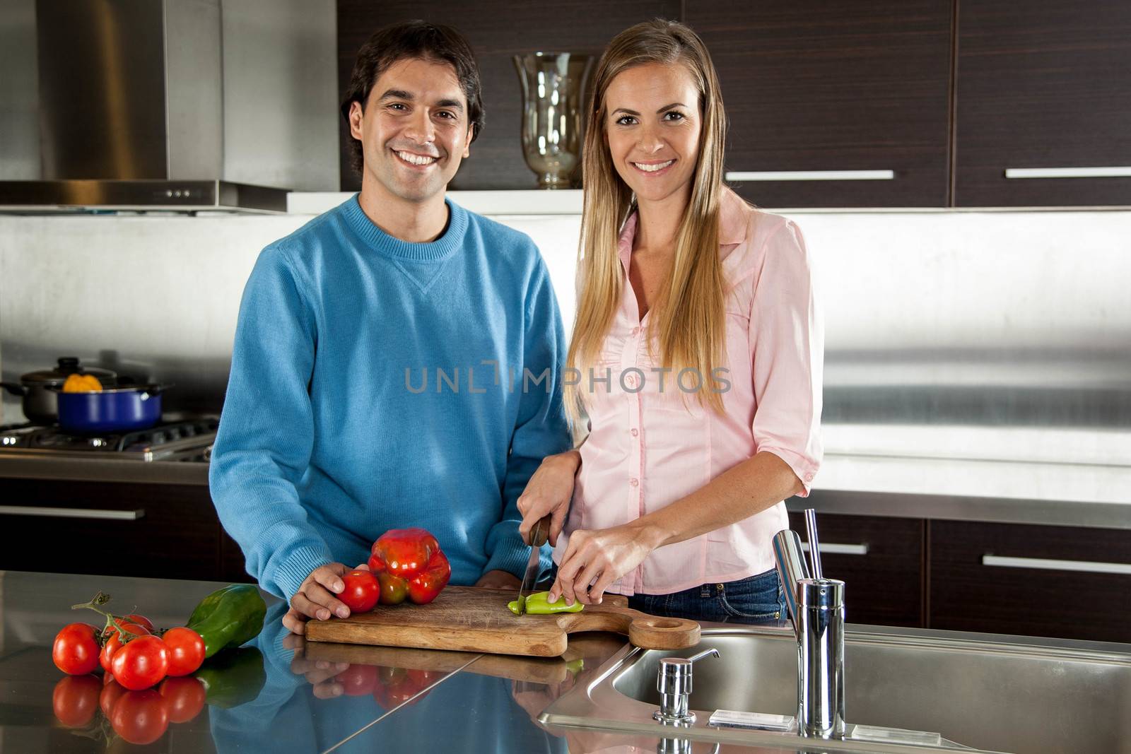 couple cutting vegetables
