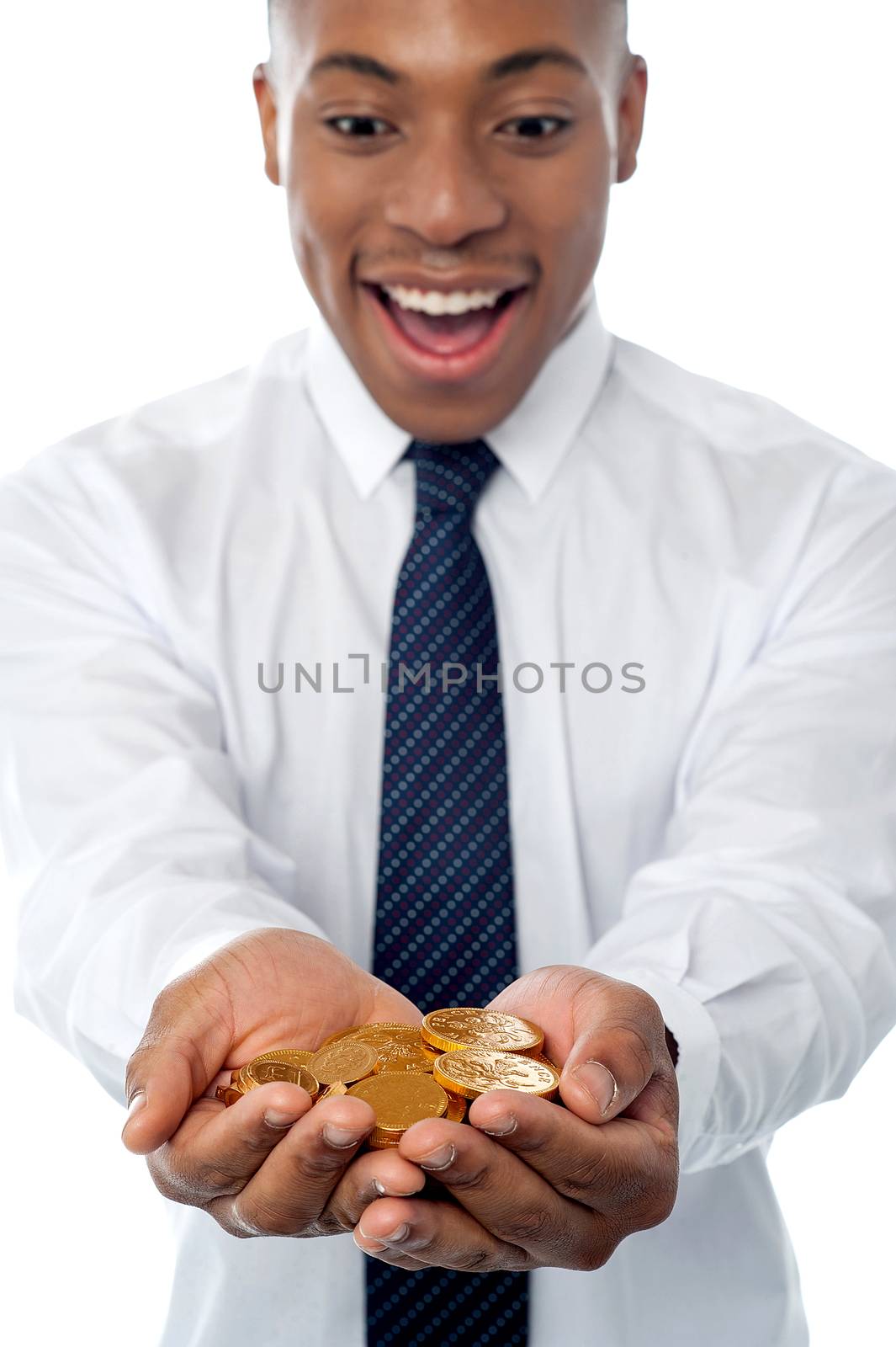 Excited businessman showing gold coins to camera