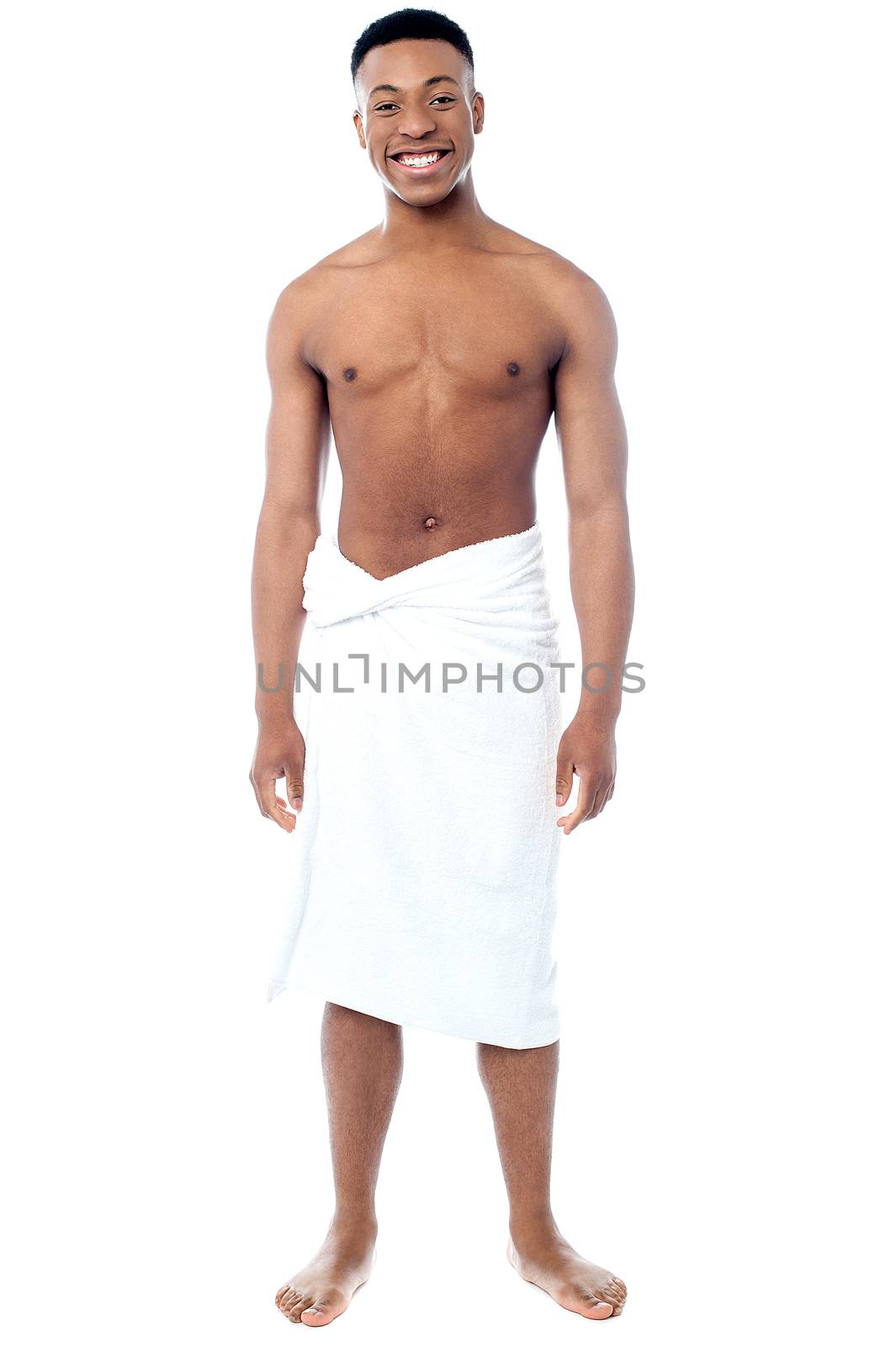 Happy young man with the towel around his waist