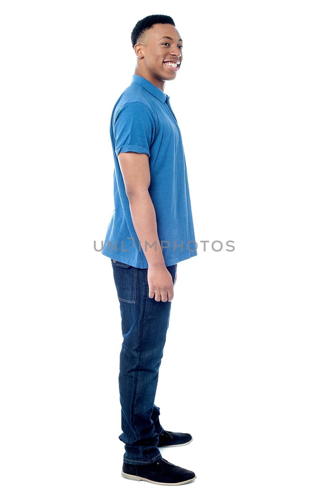 Full length image of young man posing sideways