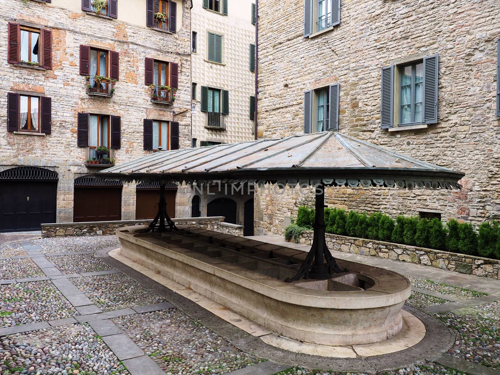 Public medieval laudry in Bergamo square by rigamondis