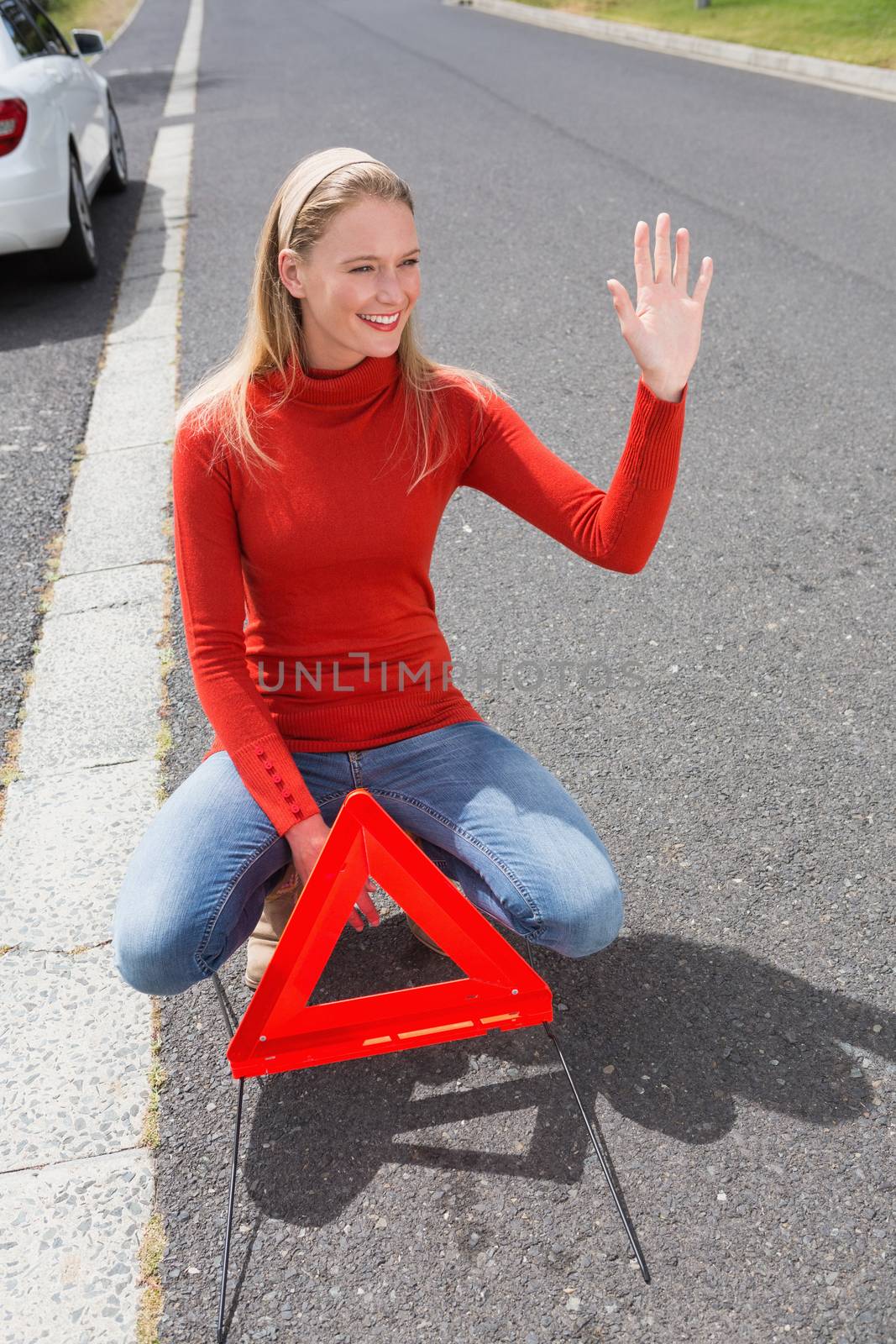 Smiling pretty woman hitch hiking in the street