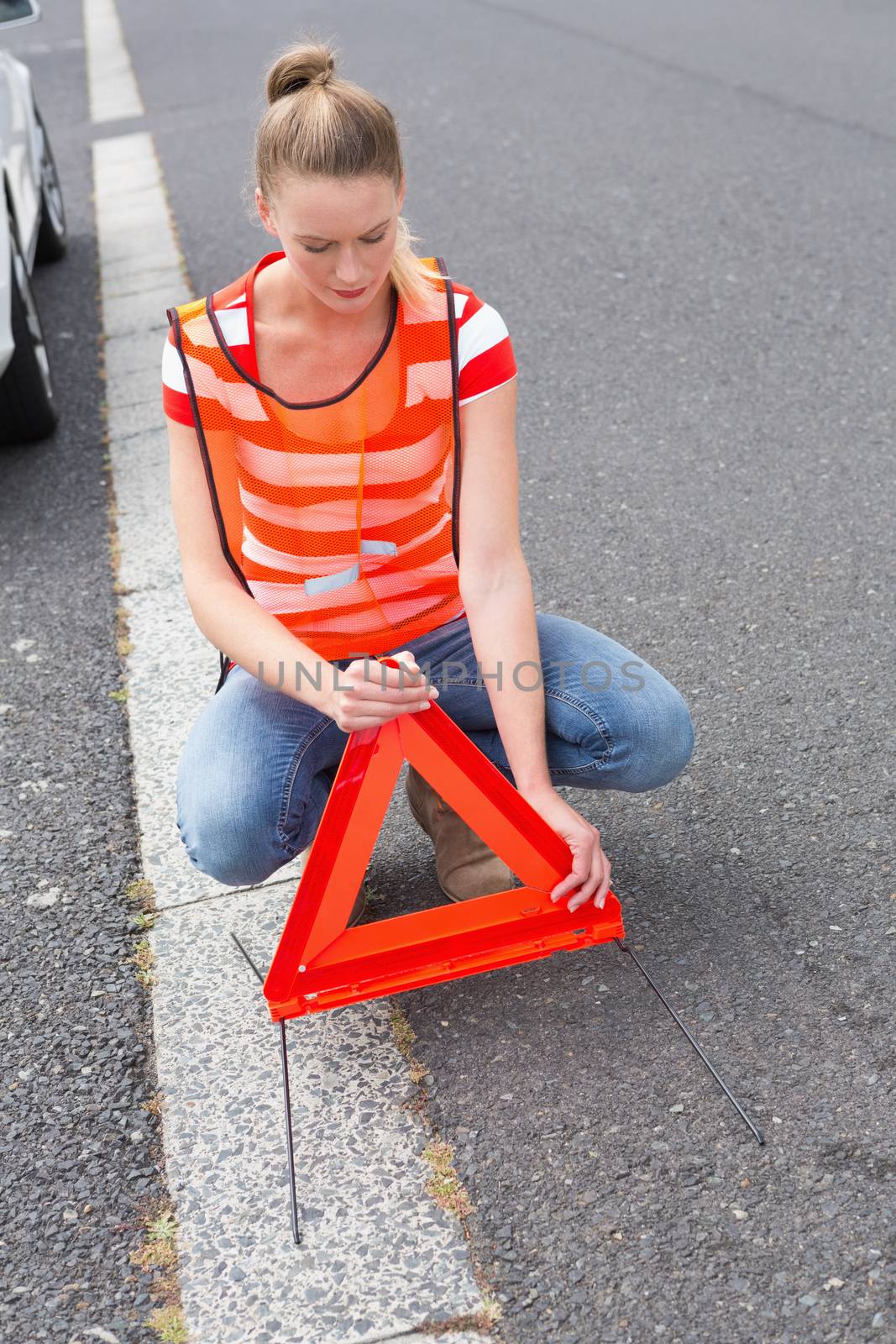 Triangle warning sign with broken down car 