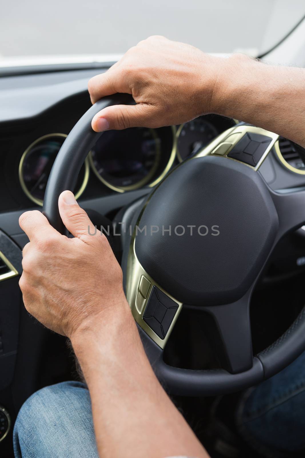 Close up of man holding his wheel in his car