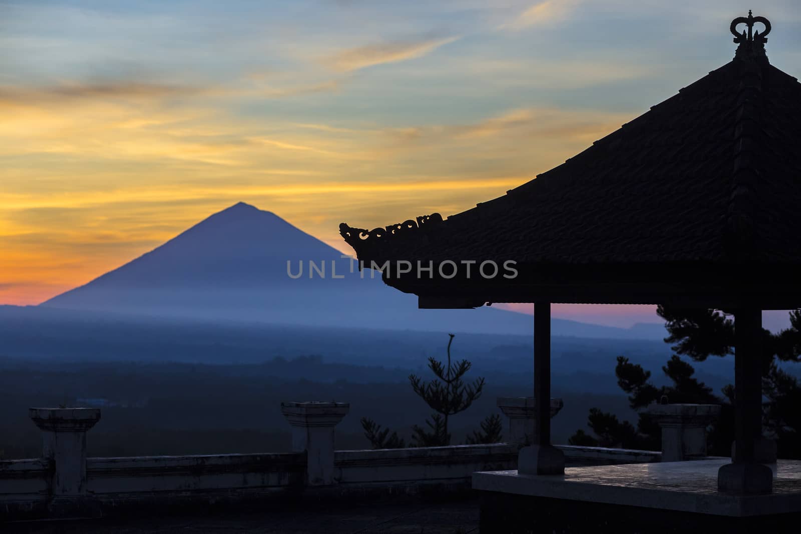 Man with and Volcano Agung as Background at Sunrise Time,Bali,Indonesia.