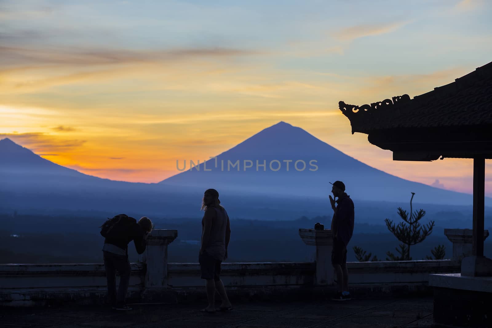 Men and Volcano Agung as Background at Sunrise Time,Bali,Indonesia.