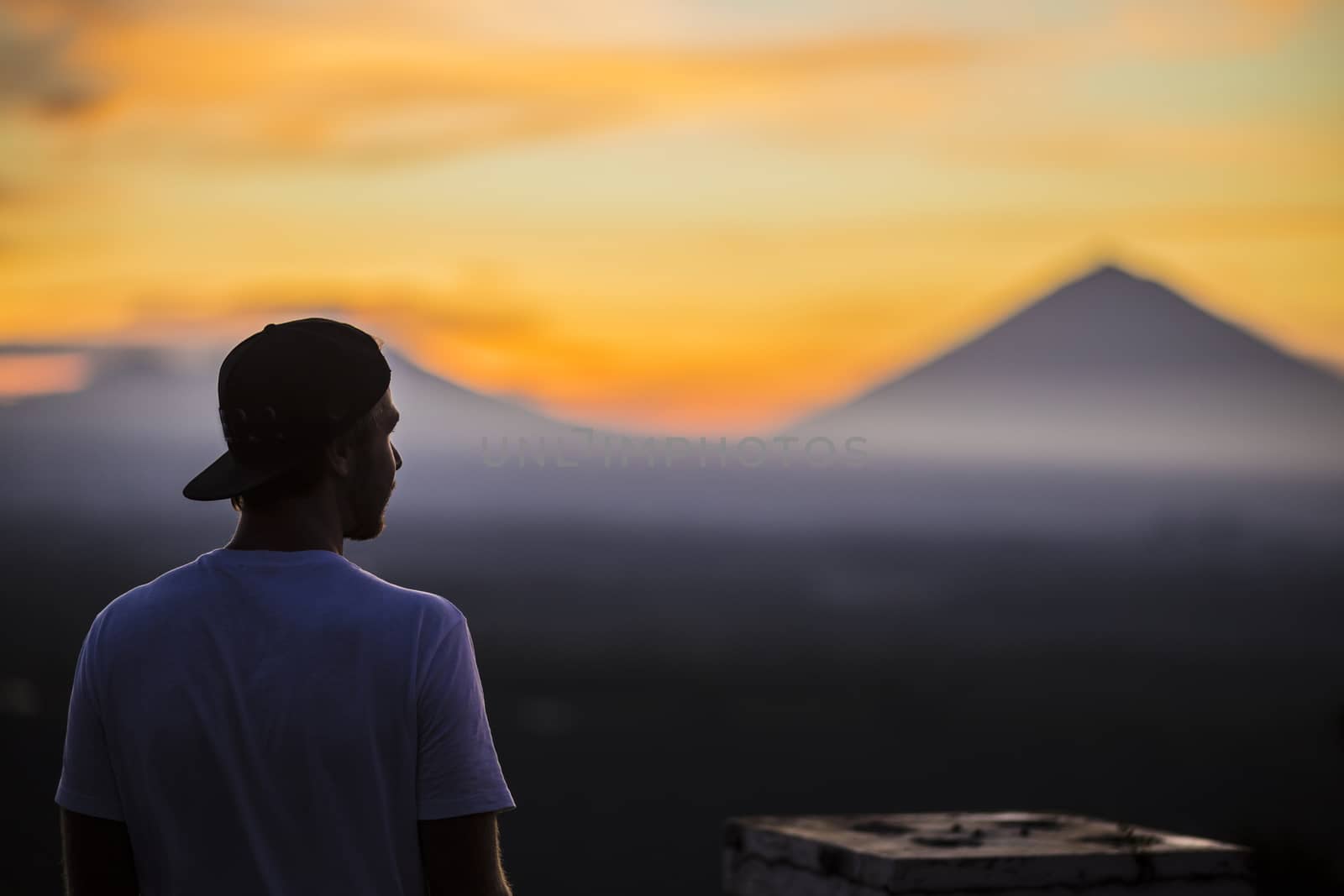 Man and Volcano Agung as Background.at Sunrise Time,Bali,Indonesia.
