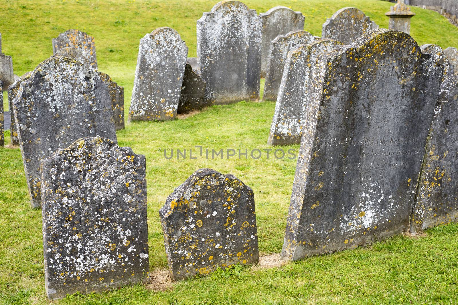 gravestones at ancient cemetery by morrbyte