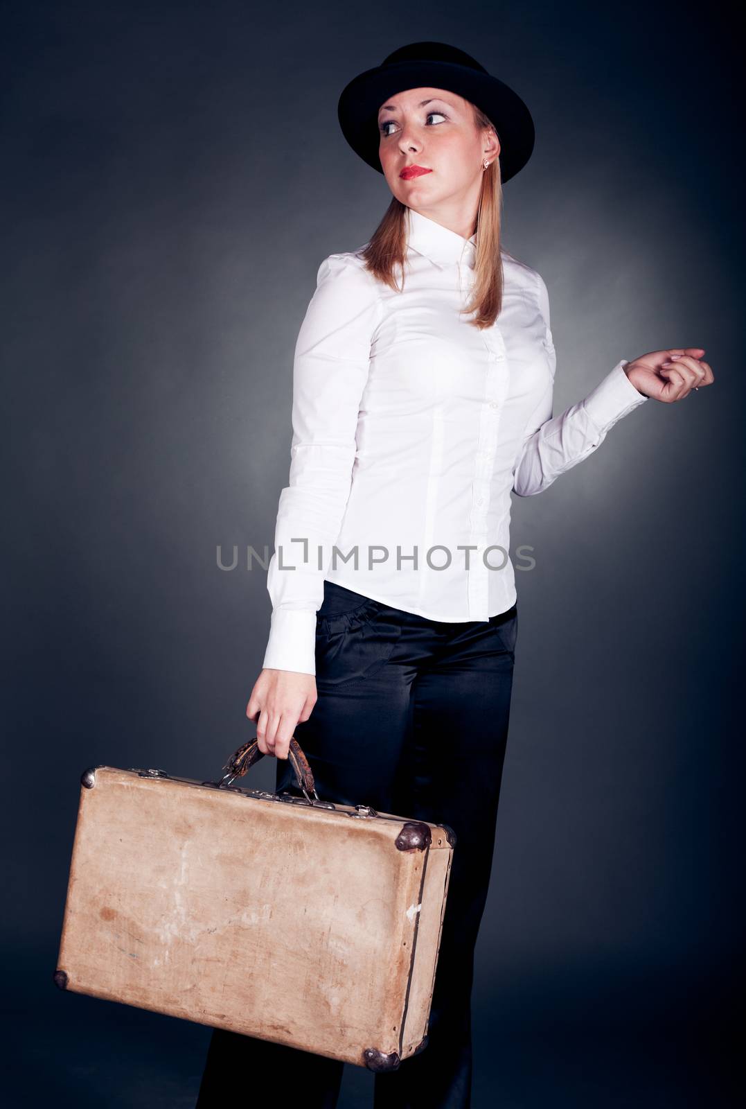 studio shot of gangster styled women with suitcase
