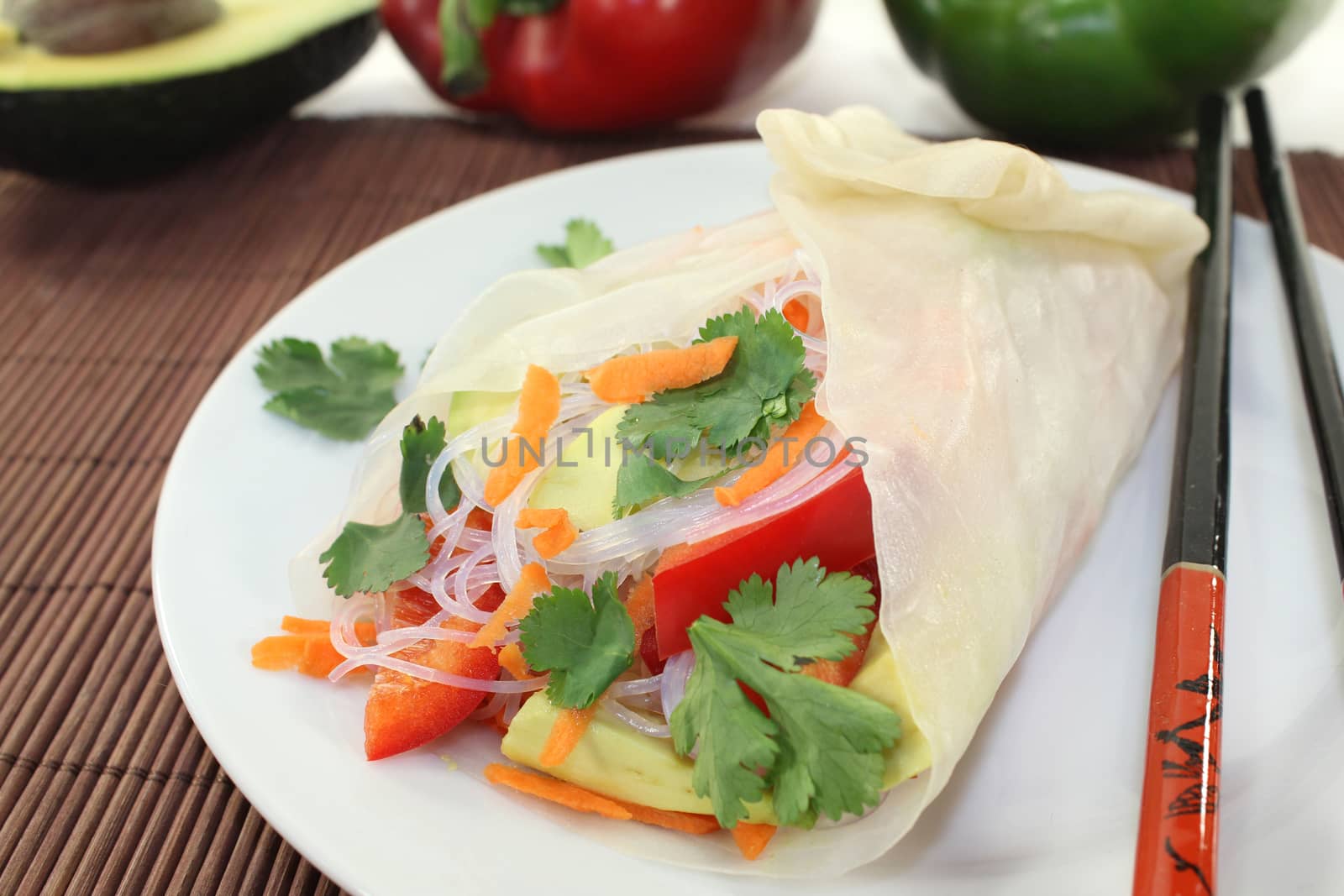 Rice paper stuffed with glass noodles, carrots, peppers and cilantro