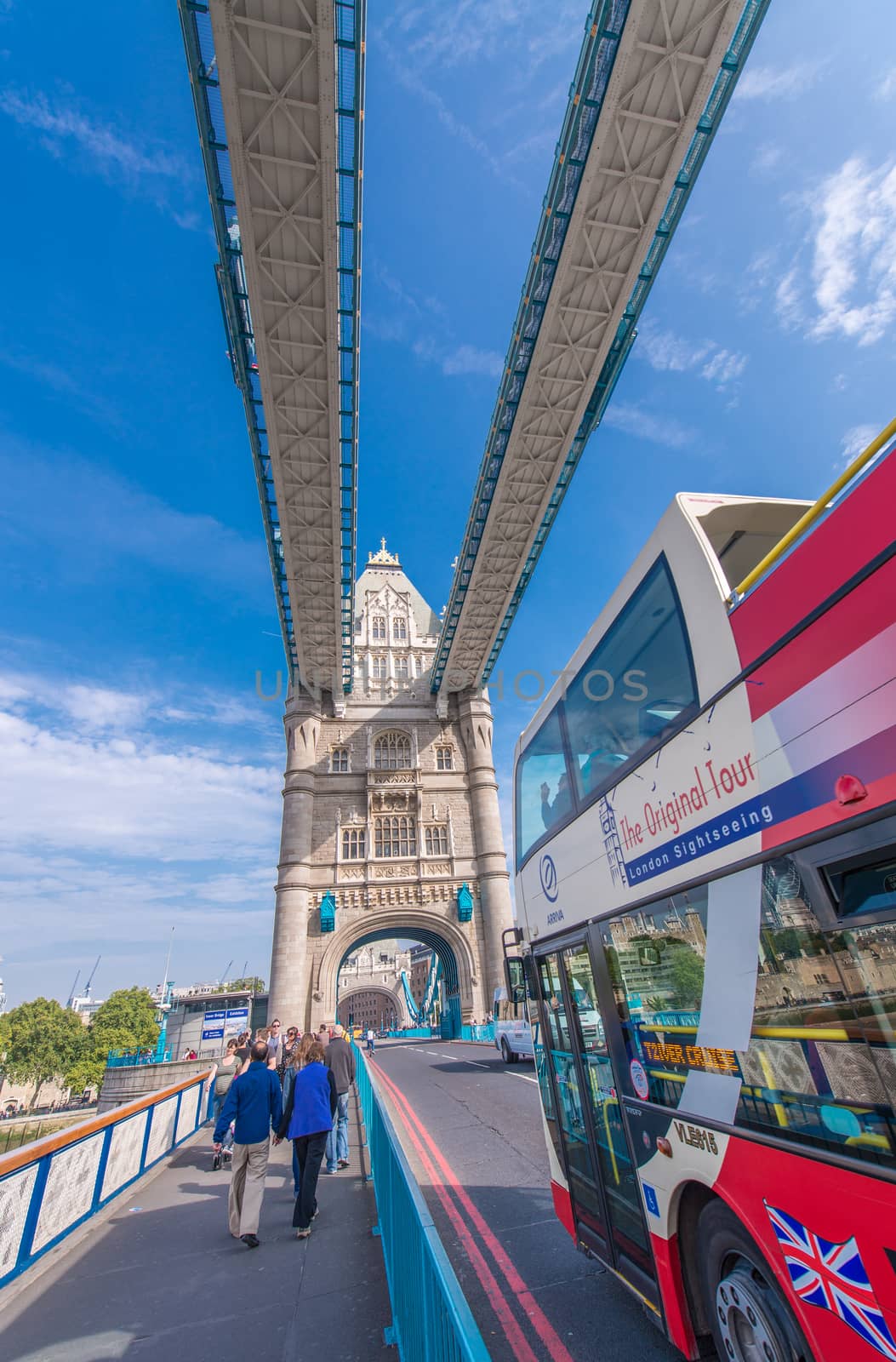 LONDON - SEPTEMBER 28, 2013: Bus crossing Tower Bridge with tou by jovannig
