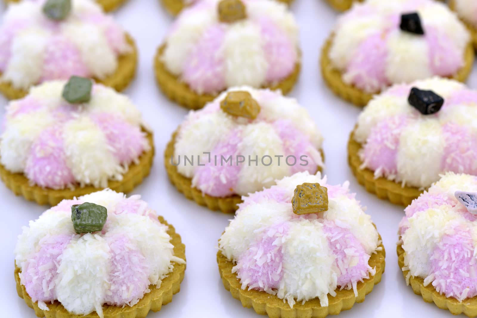 Several coconut cookies with chocolate stripes decorated with chocolate pebble