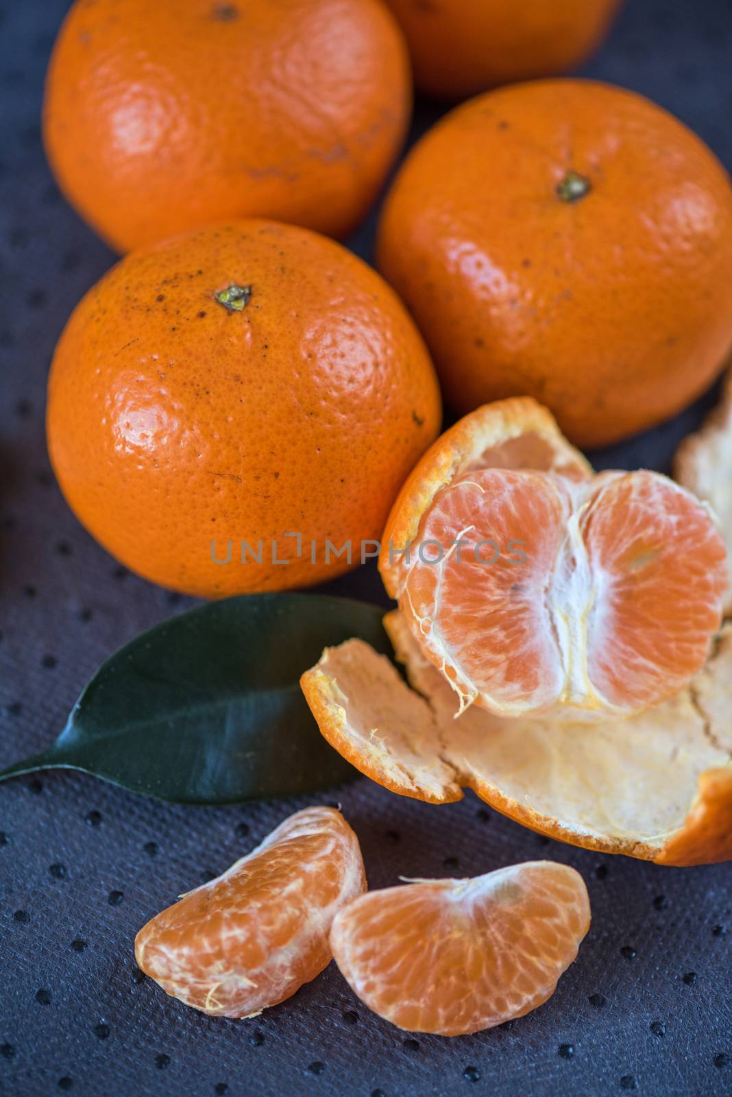Ripe tangerines on wooden background