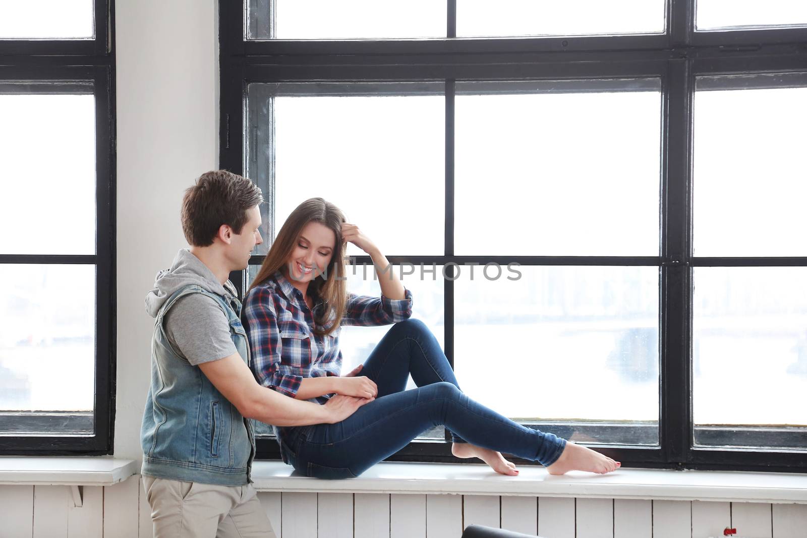 Love, relationship. Beautiful couple by the window