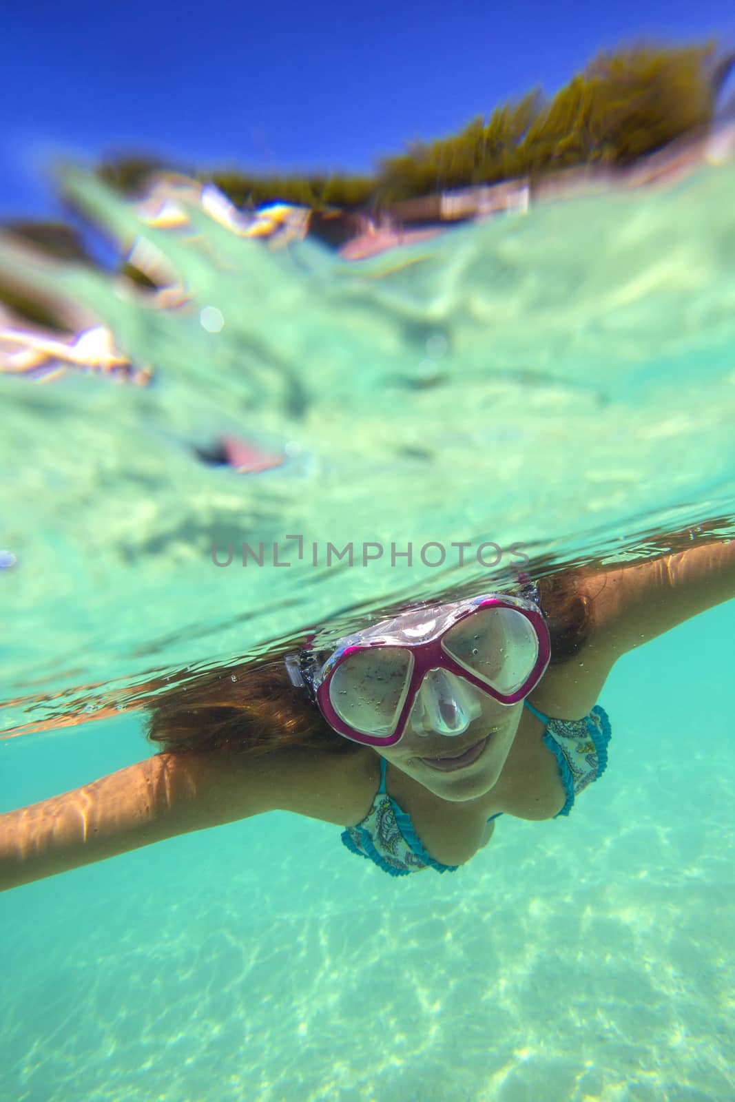 Underwater Portrait of a Yong Woman Snorkeling in Ocean.