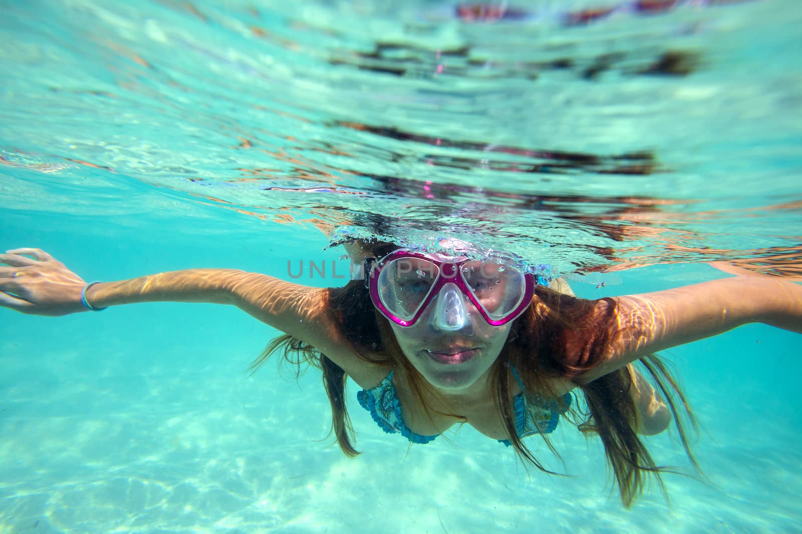 Underwater Portrait of a Yong Woman Snorkeling in Ocean.