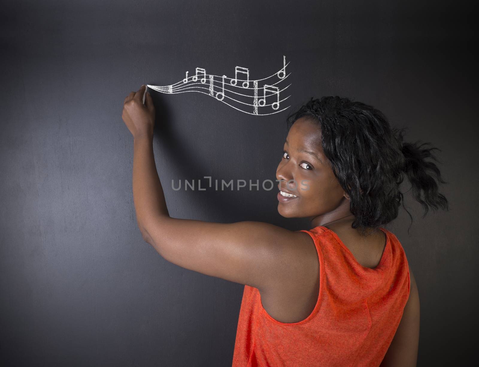 Learn music South African or African American woman teacher or student with chalk music notes blackboard background