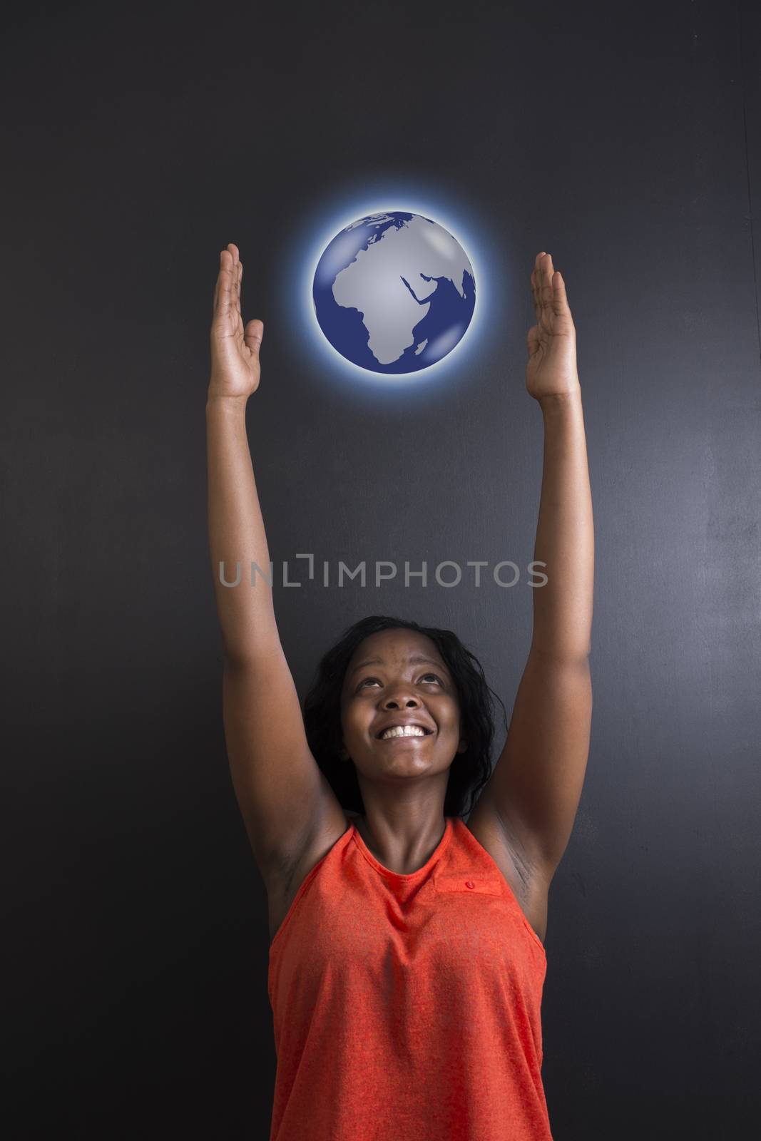 South African or African American woman teacher or student reaching for world earth globe by alistaircotton