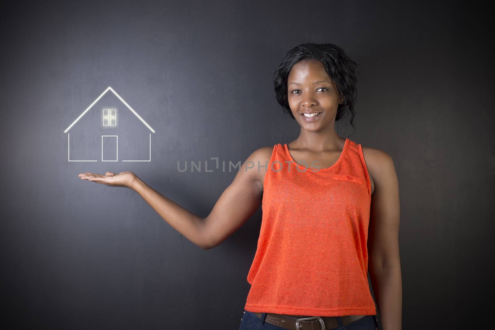 South African or African American woman teacher, student, saleswoman or businesswoman against black background holding house, home or real estate