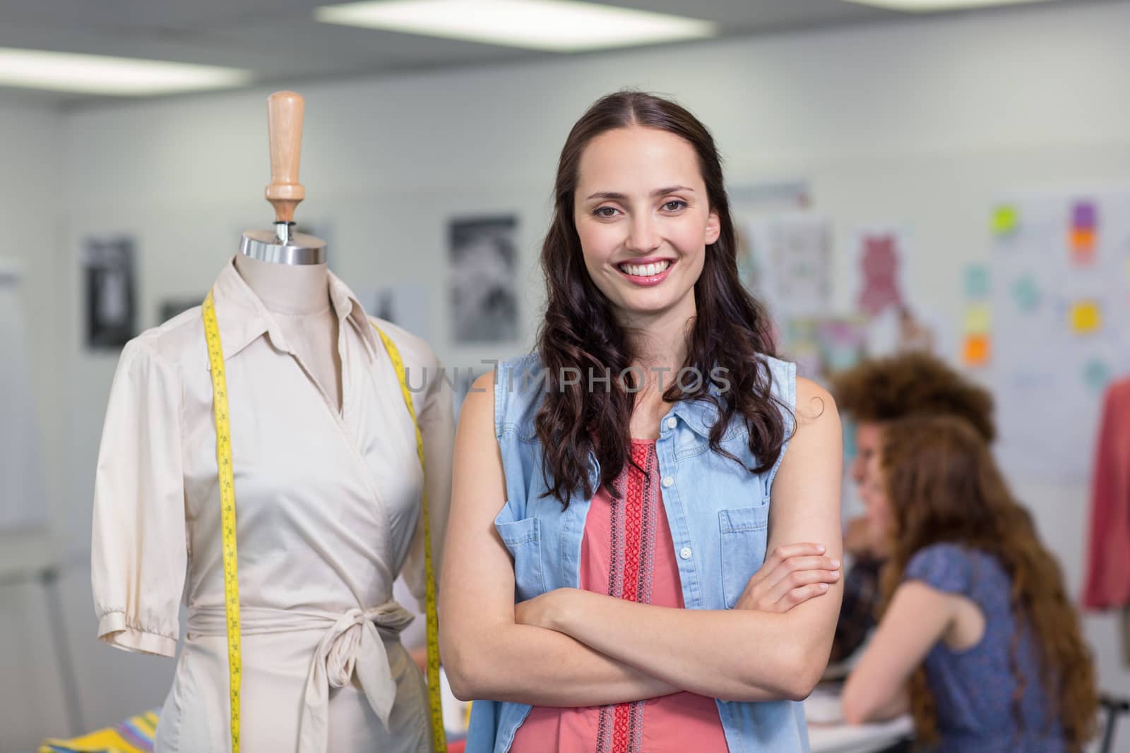 Confident female fashion designer with arms crossed by Wavebreakmedia