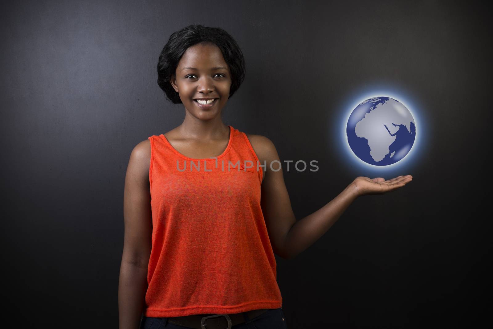 South African or African American woman teacher or student holding world earth globe in the palm of her had on black background