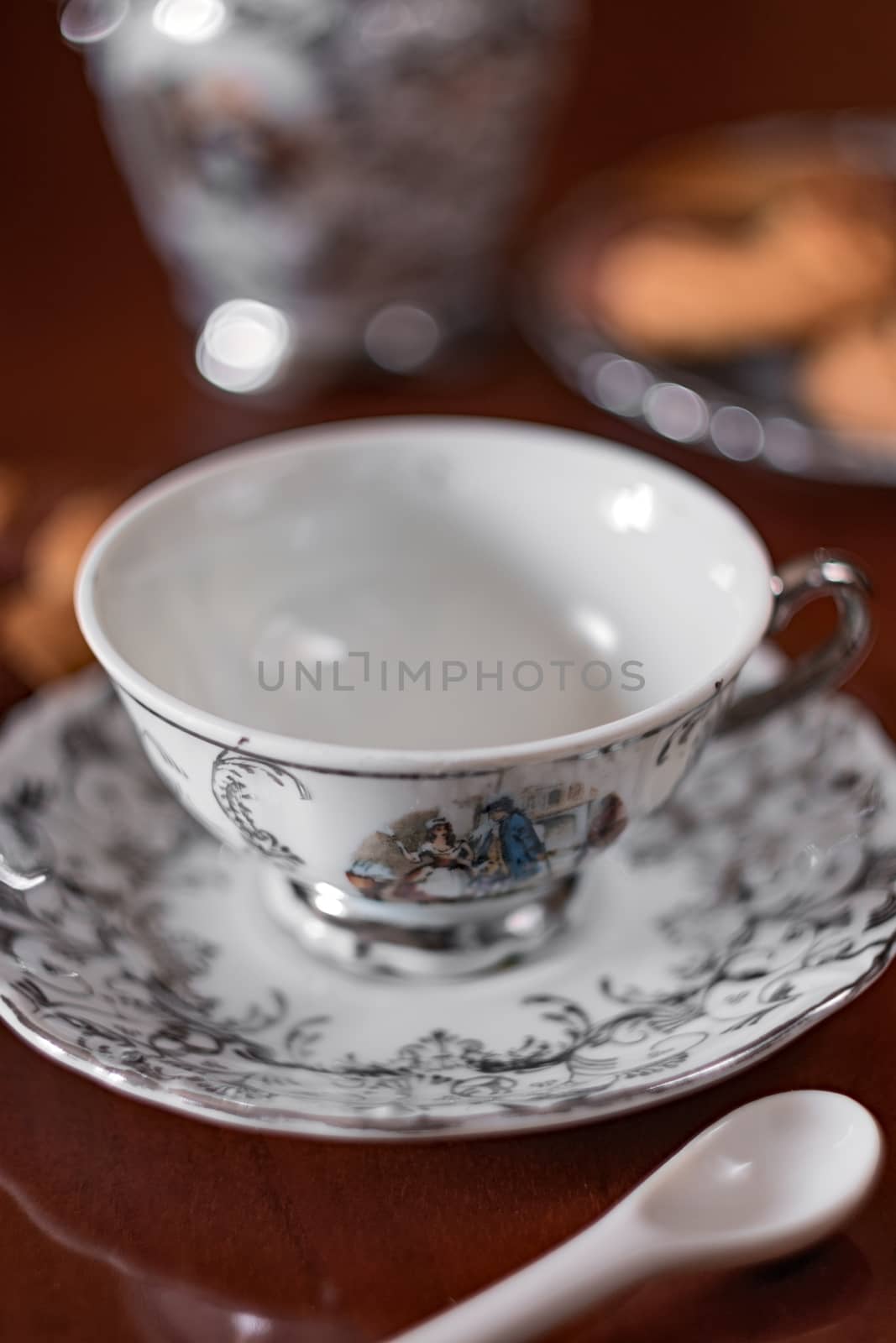 image depicting an elegant teacup decorated in the foreground