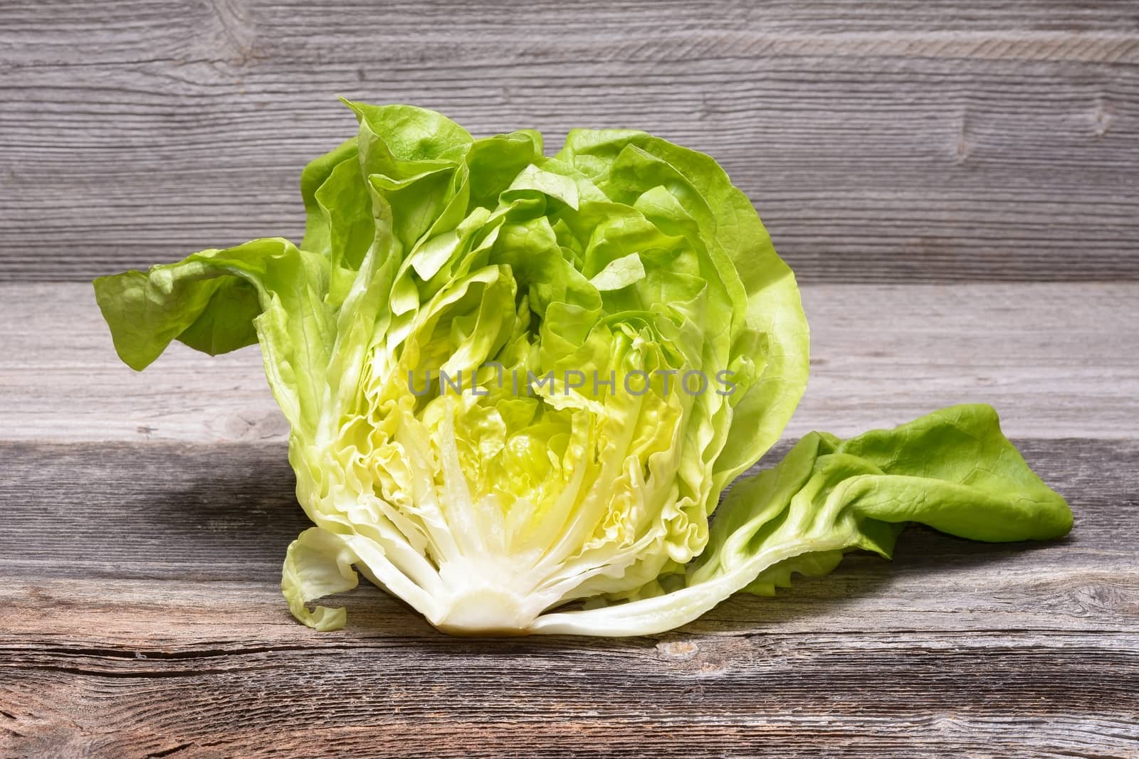 Fresh lettuce on wooden table by comet