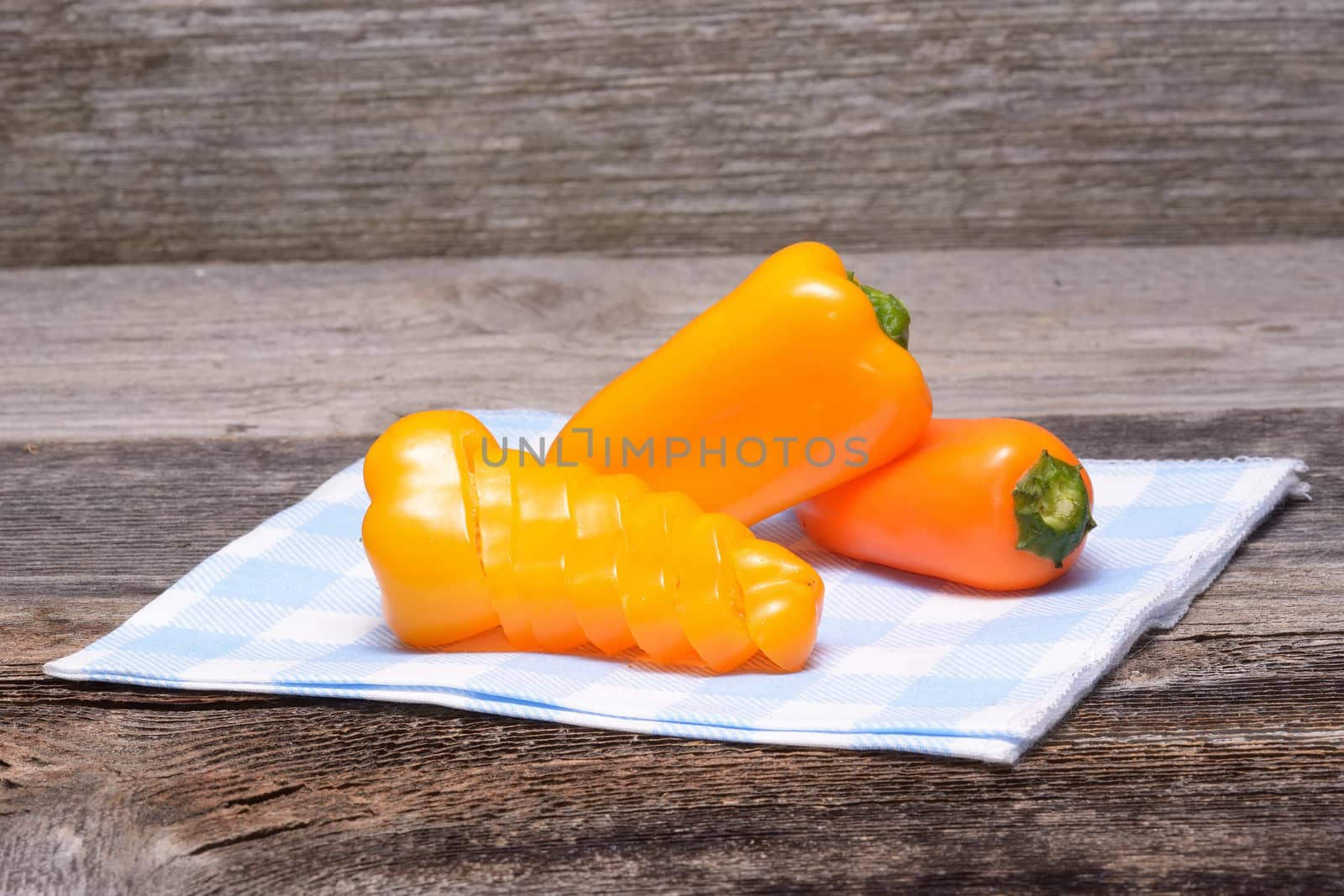 Fresh colorful capsicum on a wooden background