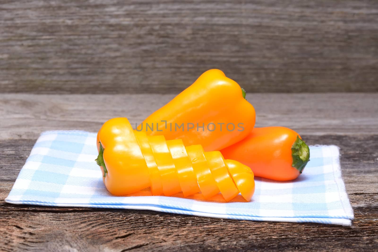 Fresh colorful capsicum on a wooden background