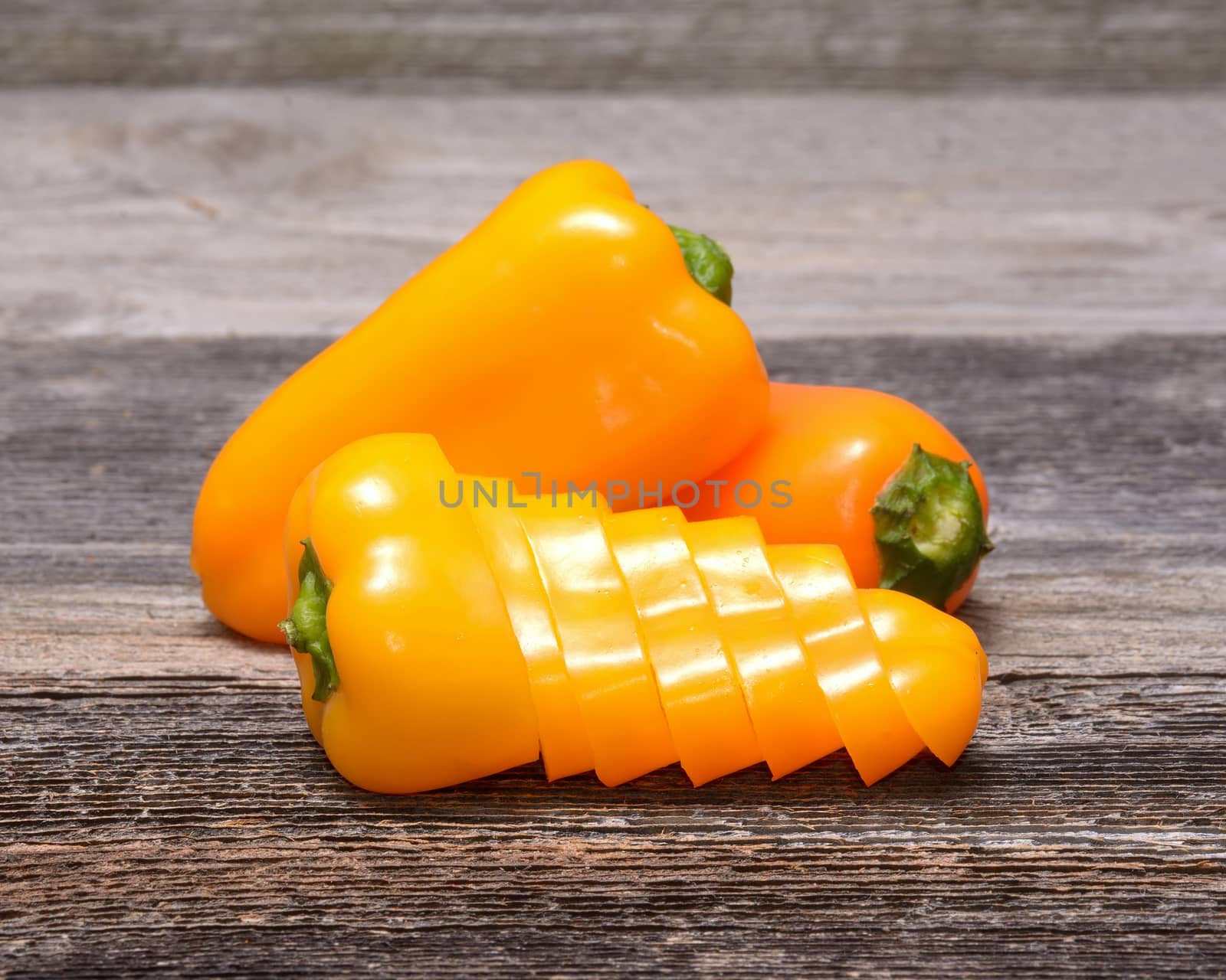Fresh colorful capsicum on a wooden background
