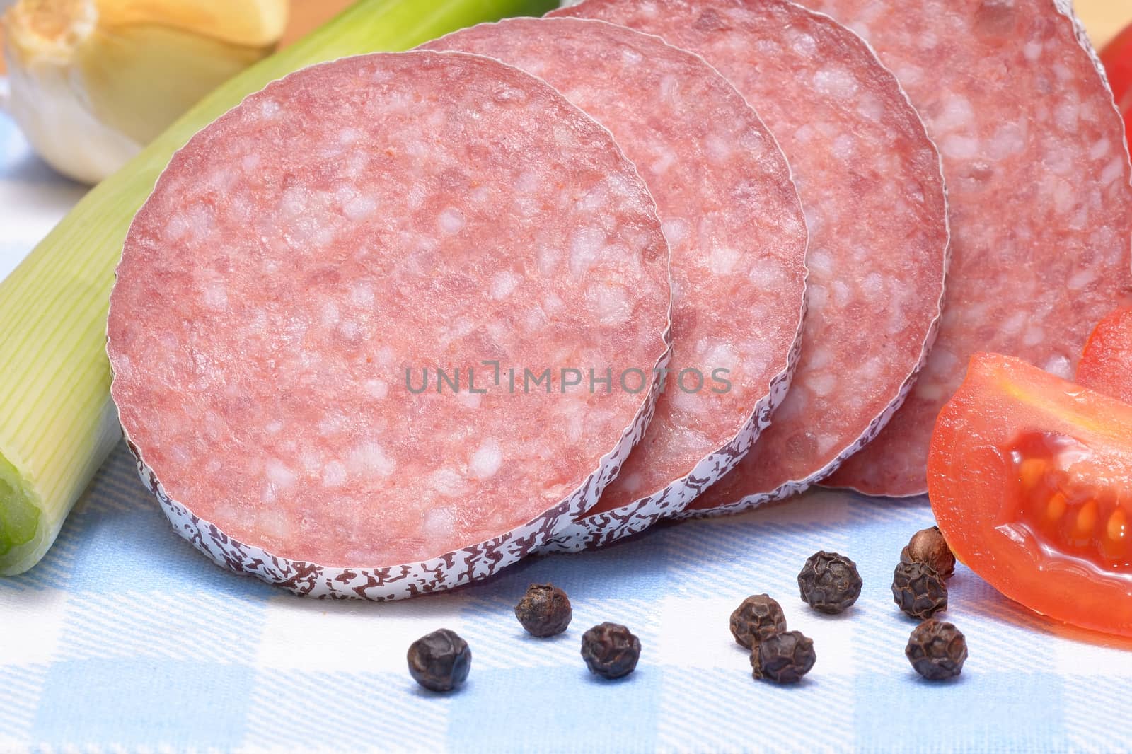 Salami sausage on wooden table by comet