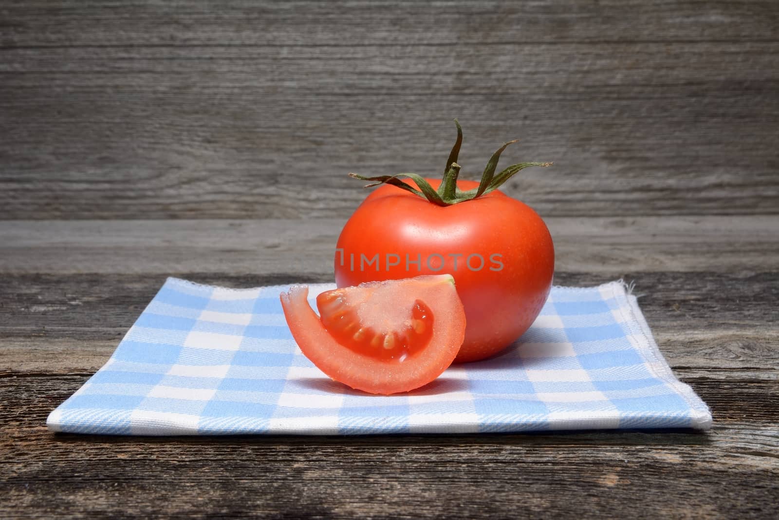 Fresh tomatoes on wooden background by comet