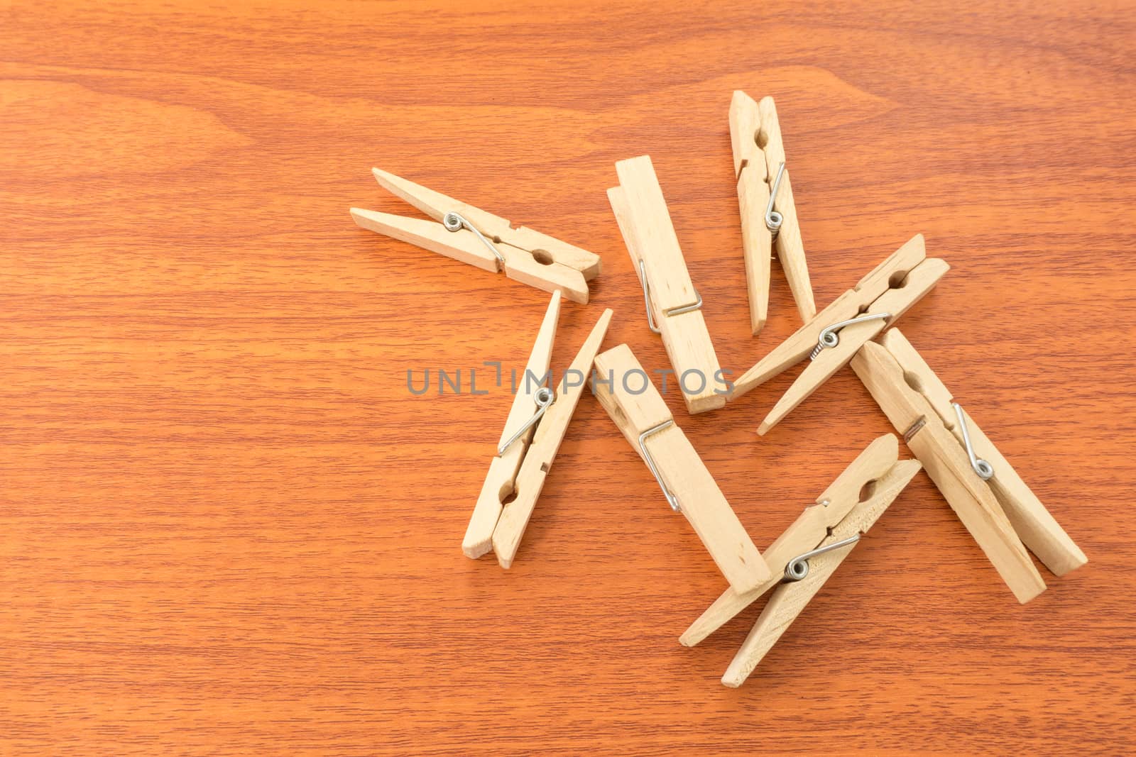 Mix Wood Clothespins on Red Wood Surface by ekgapark