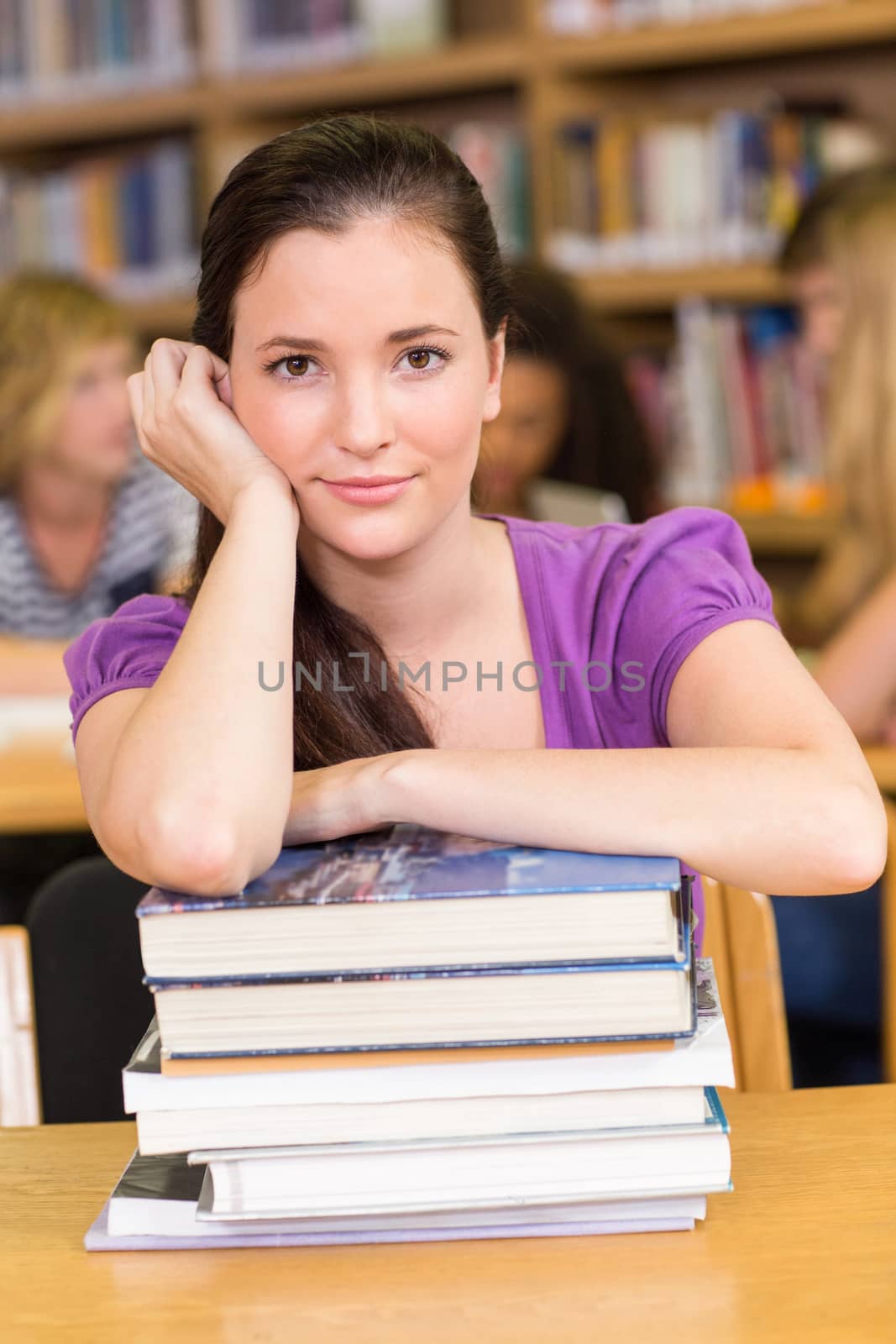 Portrait of female student sitting in the library