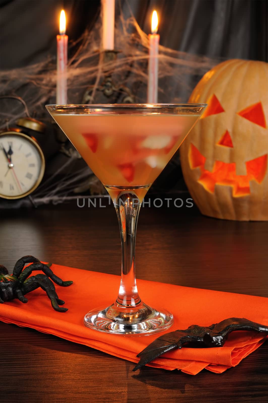 Cocktail glass filled with vampire teeth on the table for Halloween