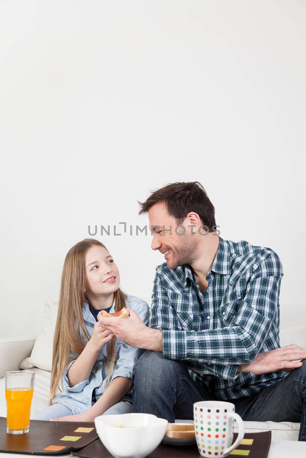 Father having a breakfast with his daughter