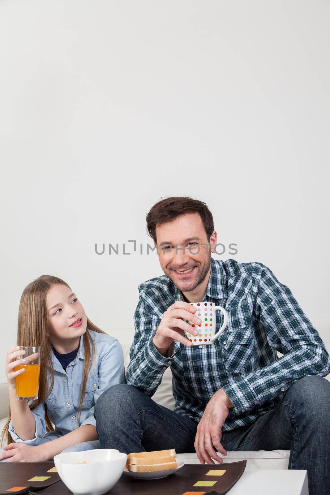 Father with his daughter having a brakfast