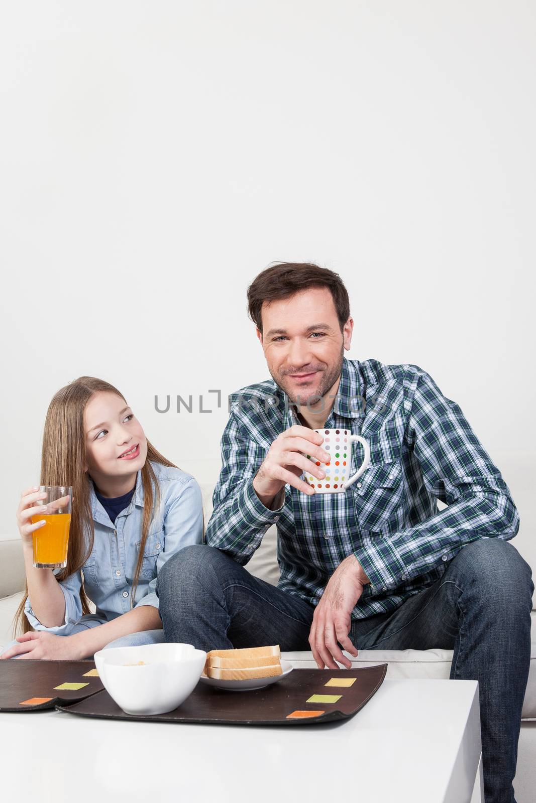 Father with his daughter having a brakfast by ifilms