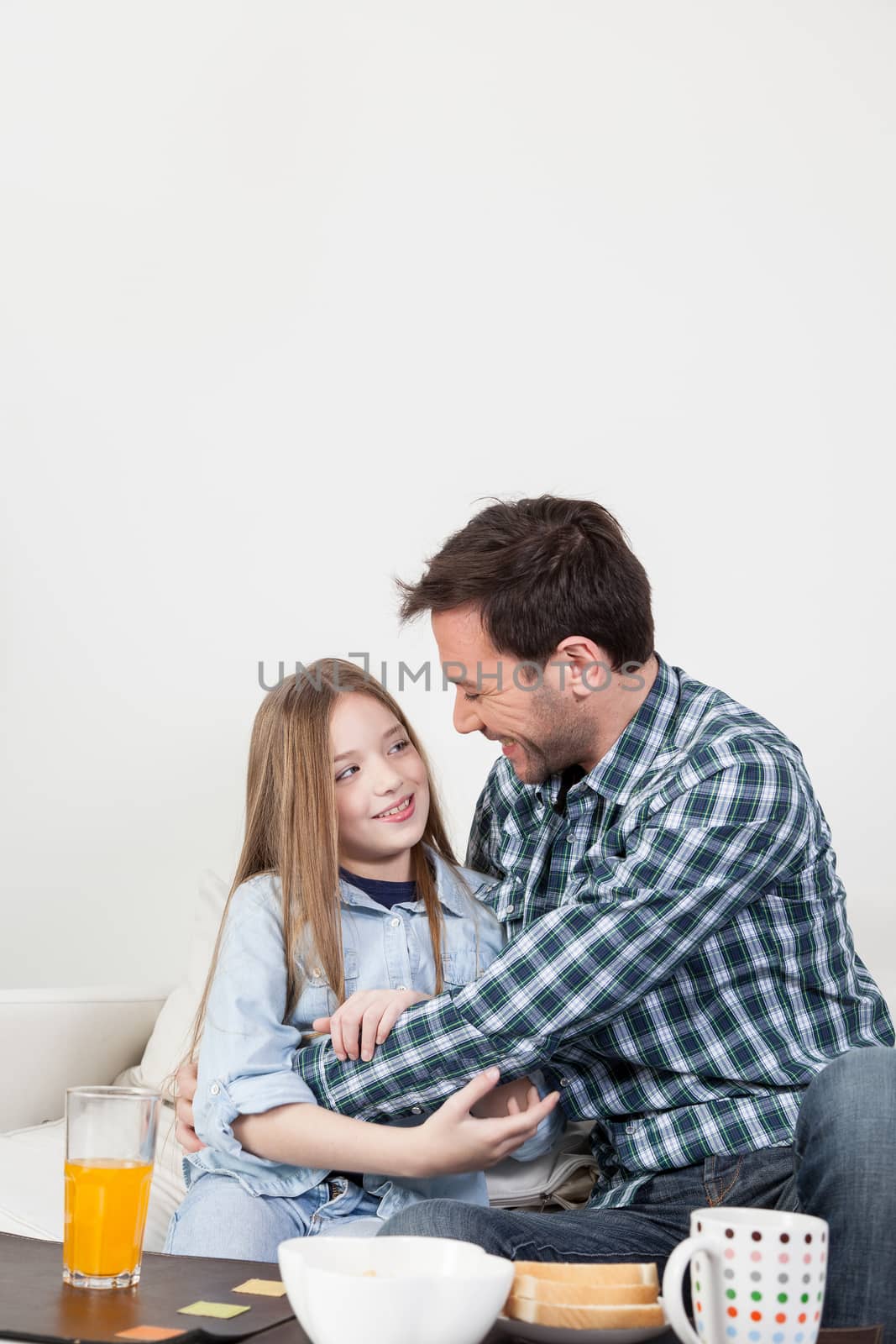 Father and daughter giving a hug in the breakfast