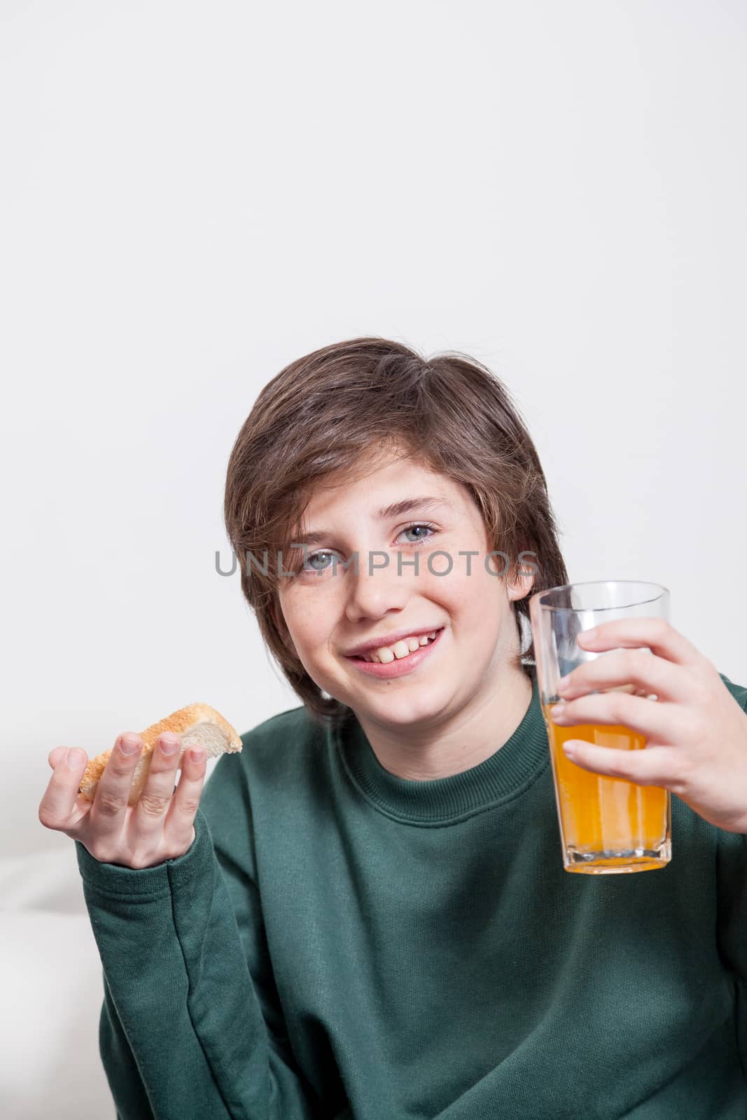Boy holding a juice and a toast