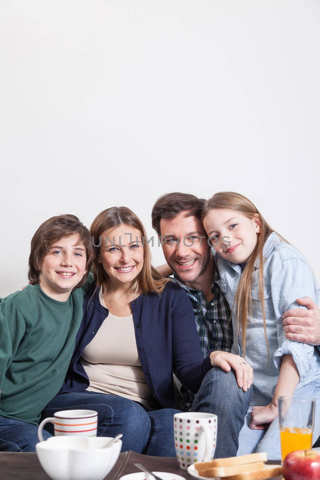 Happy couple with your childrens sitting