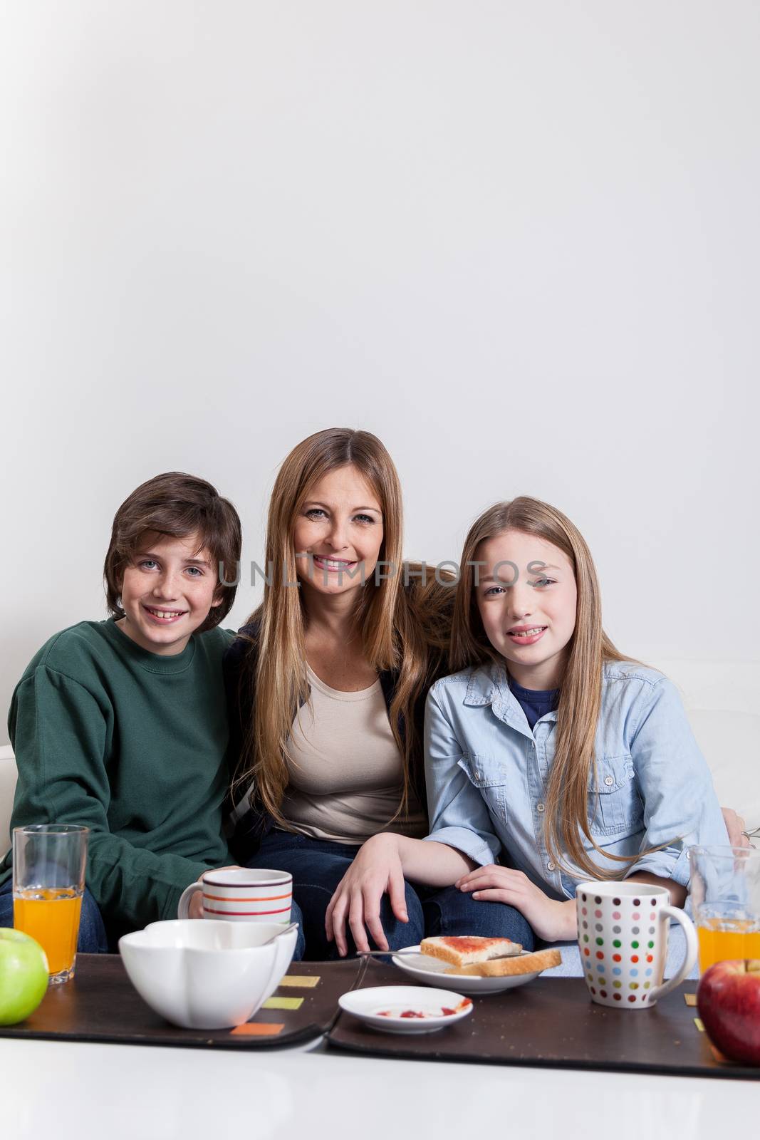 Woman having the breakfast with your sons