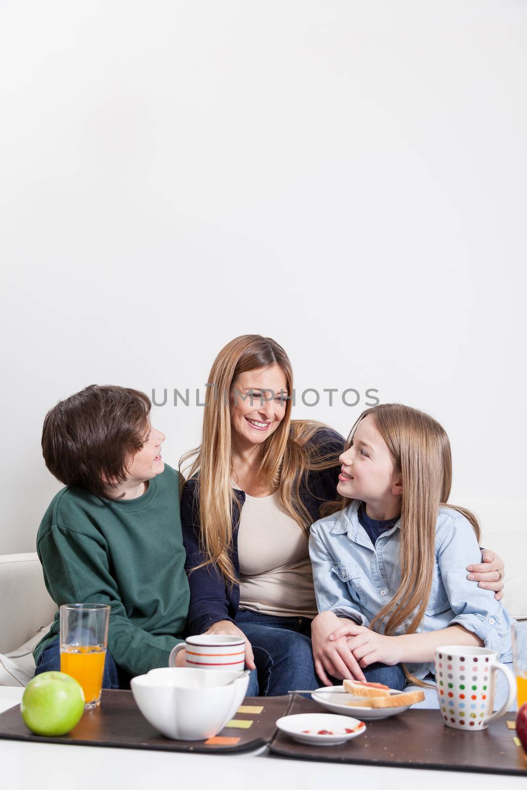 Woman having the breakfast with your sons