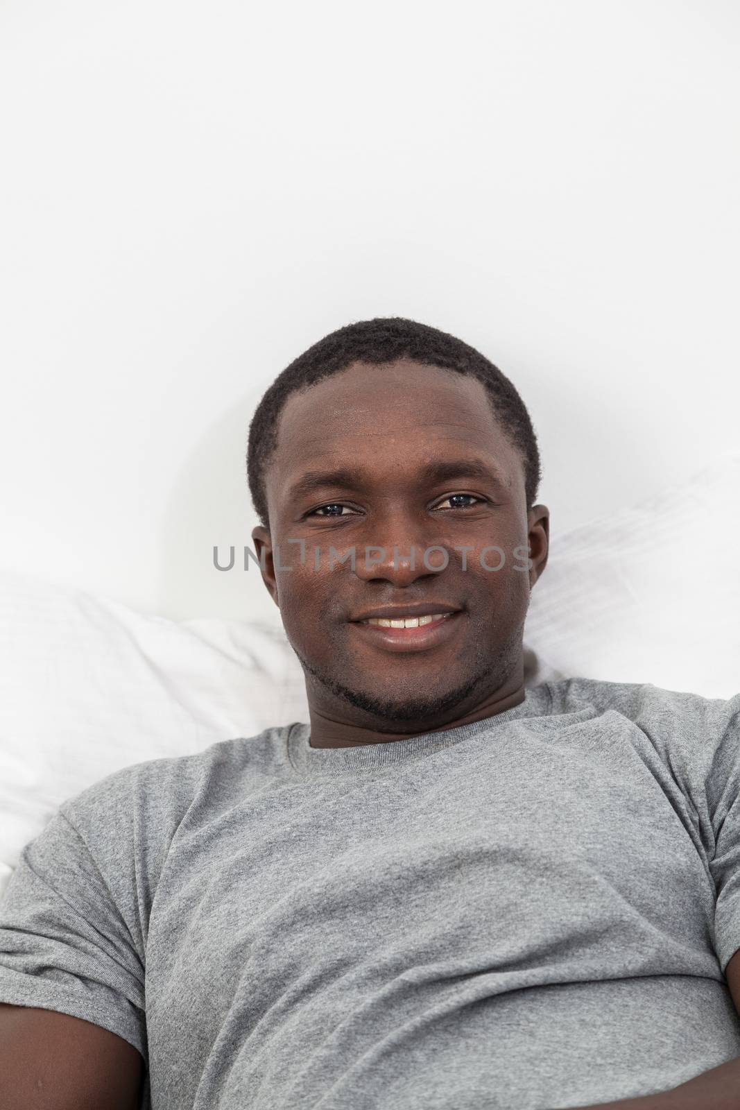 Black man lying in bed