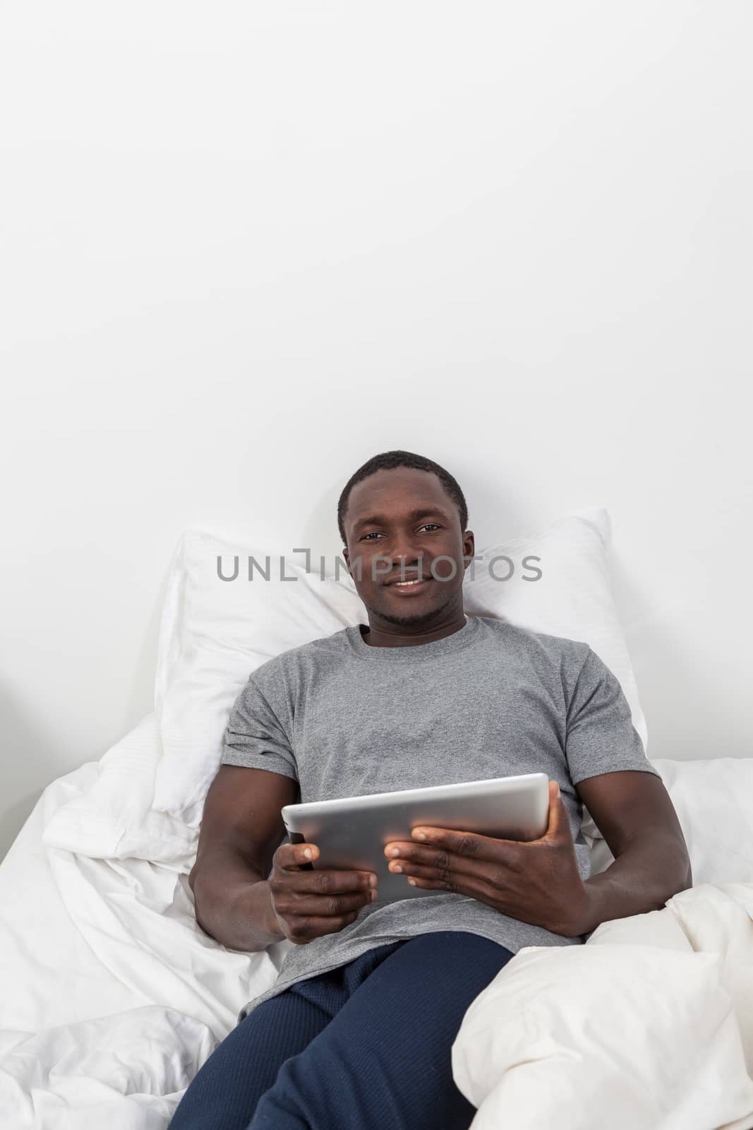 Black man looking at his tablet