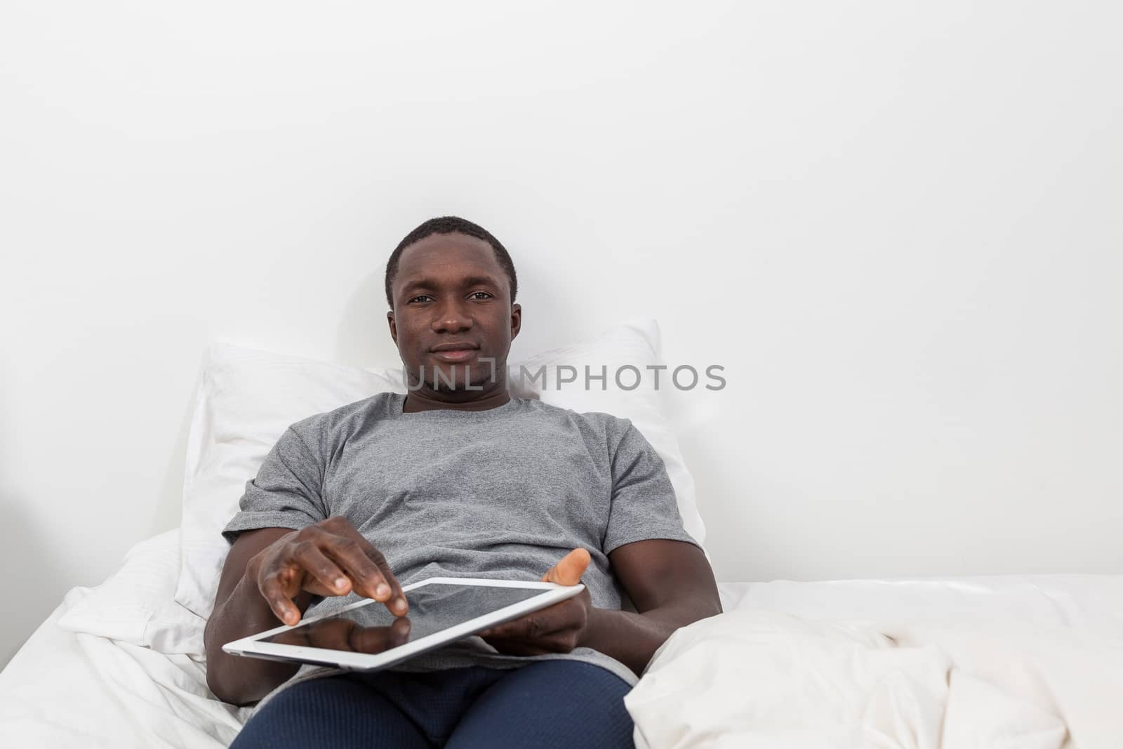 Man touching the screen of his tablet