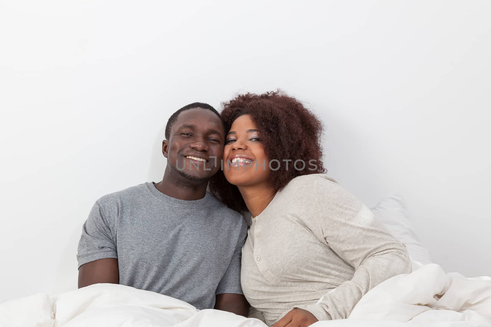 Couple relaxing in bed by ifilms