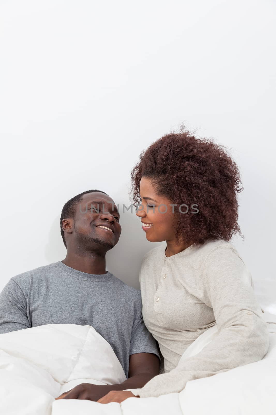 couple relaxing in bed by ifilms