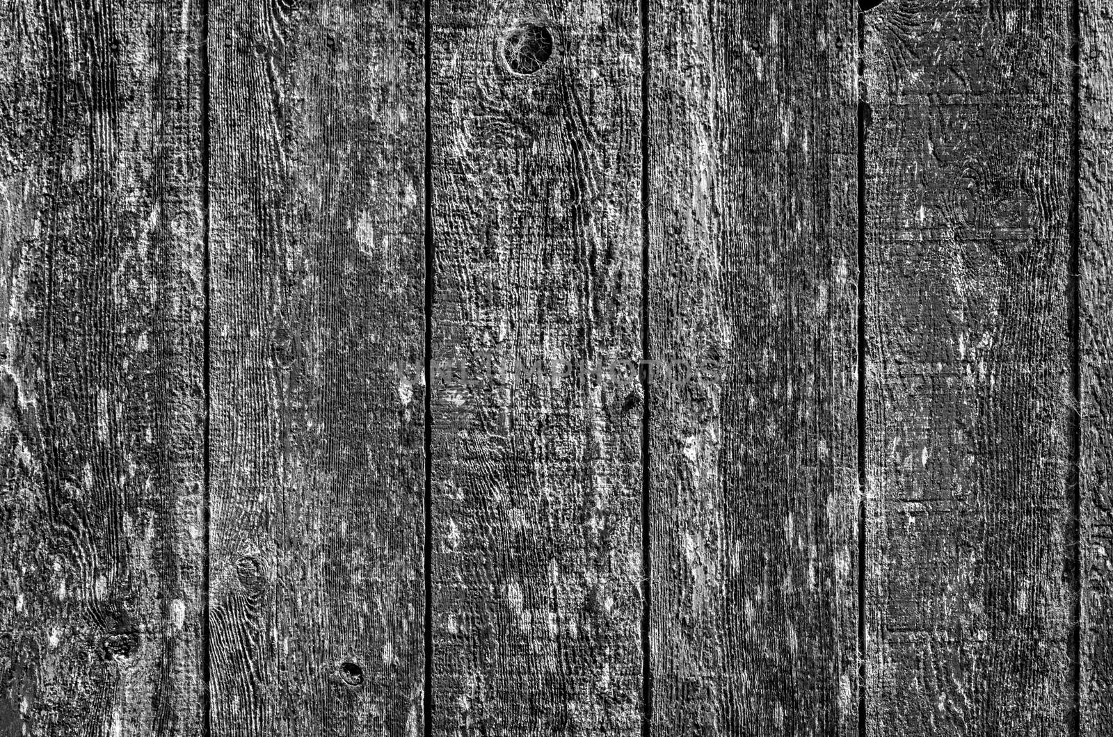 Black and white image of the side of an old barn.